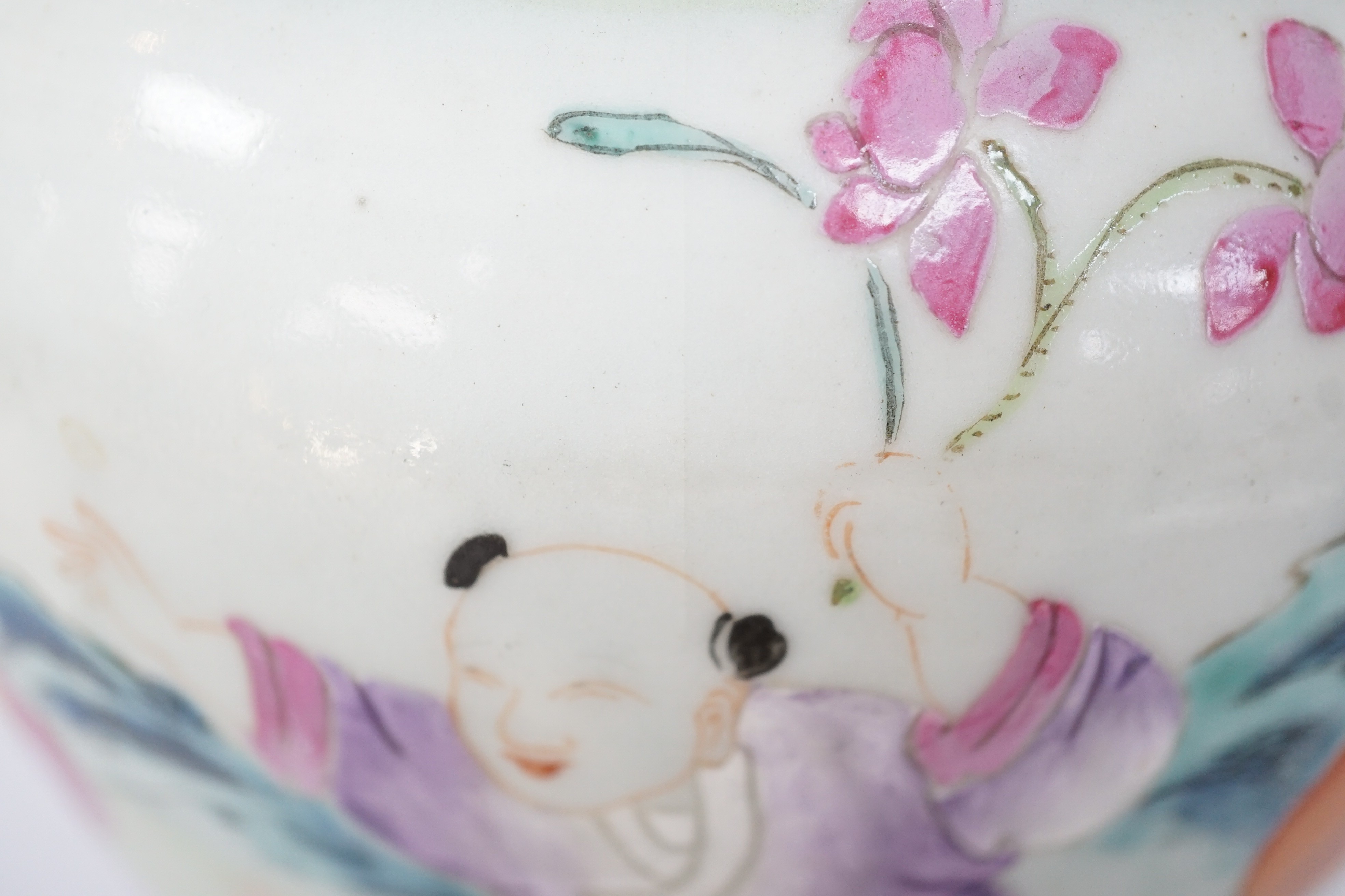 A pair of Chinese famille rose fencai ‘boys’ baluster vases, 19th century, 39.7 and 40cm high, hairline cracks